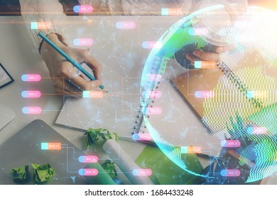 Double exposure of hands making notes with world map hologram and data theme icons. Concept of international network data.