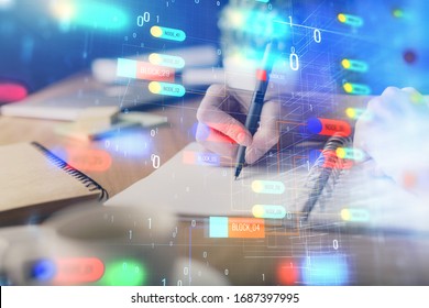 Double exposure of hands making notes with digital coding icons. Computer learning concept.