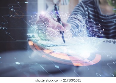 Double exposure of hands making notes with digital coding icons. Computer learning concept.