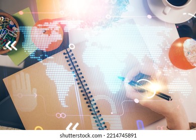 Double exposure of hands making notes with world map hologram and data theme icons. Concept of global computer data.
