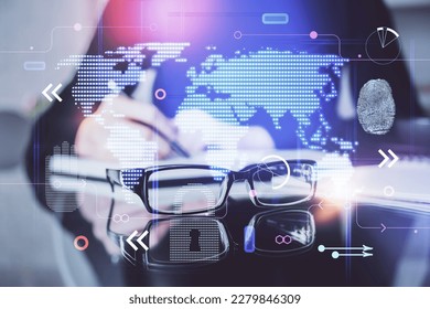 Double exposure of hands making notes with world map hologram and data theme icons. Concept of global computer data.