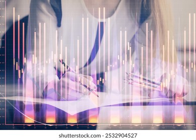 Double exposure of hands making notes with forex chart huds. Stock market concept.