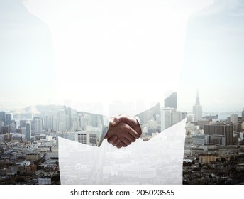 double exposure handshake businessman on city background