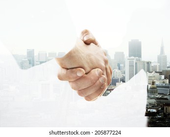 double exposure handshake on a city background - Shutterstock ID 205877224