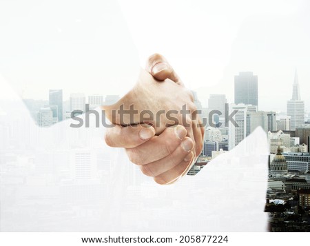 double exposure handshake on a city background