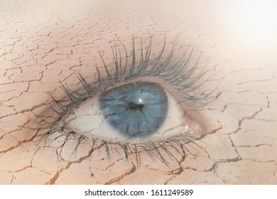 Double exposure of human eye in dry land on the background. Global warming and nature conservation concept.