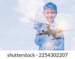 the double exposure image the boy playing the miniture airplane overlay with airplane in the sky image