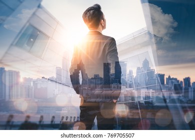The double exposure image of the business man standing back during sunrise overlay with cityscape image. The concept of modern life, business, city life and internet of things. - Shutterstock ID 769705507