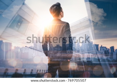 Photo of The double exposure image of the business man standing back during sunrise overlay with cityscape image. The concept of modern life, business, city life and internet of things.