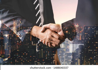 Double exposure image of business people handshake on city office building in background showing partnership success of business deal. Concept of corporate teamwork, trust partner and work agreement. - Shutterstock ID 1488040337