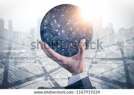 The double exposure image of the businessman hold the virtual hologram on hand and element of this image furnished by Nasa. the concept of communication network, internet of things and future life