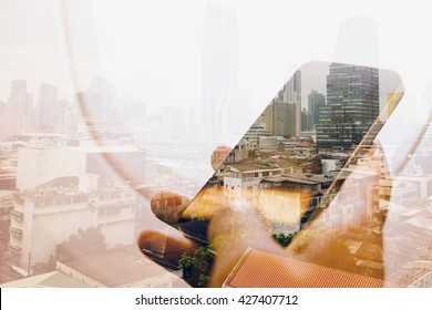 Double exposure image of businessman sitting in the airplane and using smart phone with cityscape background, Business technology concept. - Powered by Shutterstock