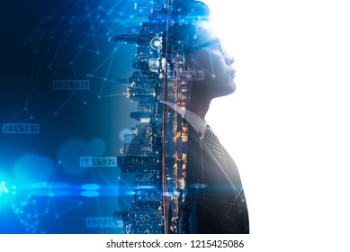 The double exposure image of the businessman thinking overlay with cityscape image and futuristic hologram. The concept of modern life, business, city life and internet of things.