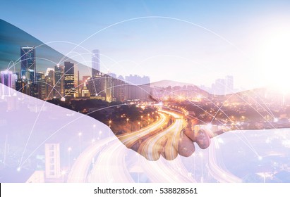 Double Exposure Of Image Of Businessmen Hand Shake, Concept Of Network Connection In Urban Life.