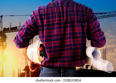 Double Exposure Image Of Construction Worker Holding Safety Helmet And Construction Drawing Against The Background Of Surreal Construction Site In The City.