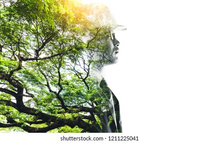 double exposure image of the engineer thinking during sunrise overlay with forest image and white copy space. the concept of clean energy, futuristic, industrial4.0 and hydroelectric.