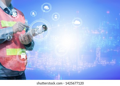 the double exposure image of the engineer using a smartphone overlay with oil refinery image.