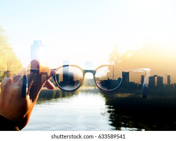 Double Exposure Image Of Hand-held Glasses Scene Is Cityscape Focus, Business Vision