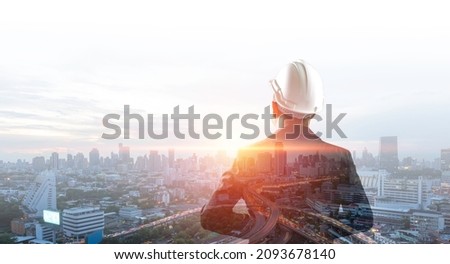 Double exposure image, Man engineer overlay with building architecture urban cityscape. Creation city and communication concept.