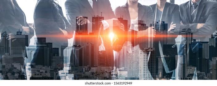 Double exposure image of many business people conference group meeting on city office building in background showing partnership success of business deal. Concept of teamwork, trust and agreement. - Shutterstock ID 1563192949
