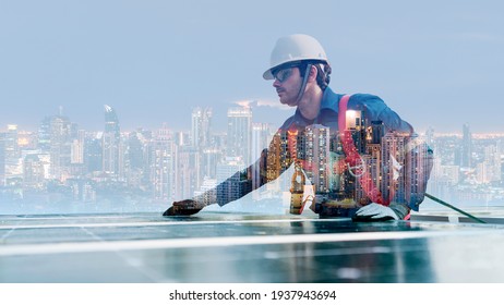 Double Exposure Image Of A Worker Installing The Solar Cell Panel Over The Night Cityscape Image Background Showing The Concept Of Sustainable Energy Alternative Energy And Environmental Conservation