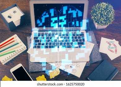 Double exposure of laptop computer and technology theme hologram. Concept of freelance work.