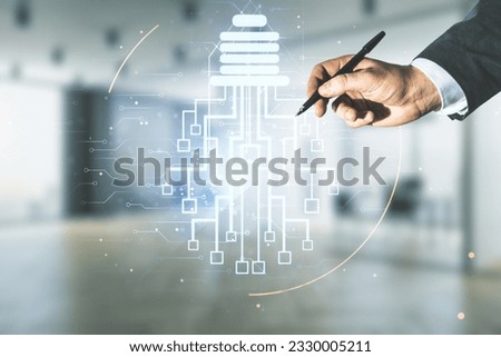 Double exposure of male hand with pen draws virtual creative light bulb hologram with chip on blurred office background, idea and brainstorming concept