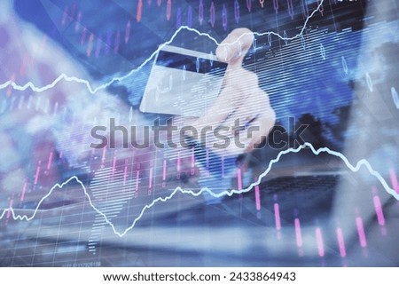 Double exposure of man hands holding a credit card and Forex graph drawing. Stock trading and digital fintech in Internet E-commerce concept.