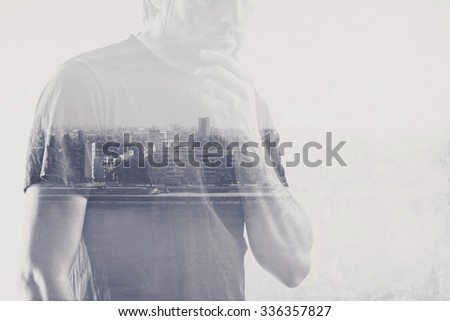 Double exposure of man thinking with hand on chin, cityscape in background.