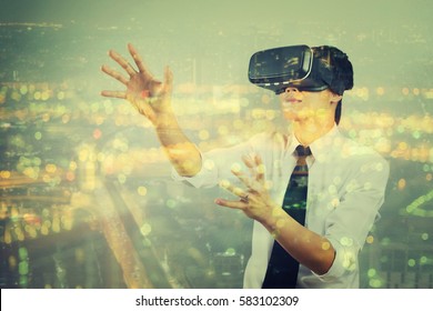 Double Exposure Man Wearing Virtual Reality  In Modern Coworking Studio. Smartphone Using With VR Box Google 3D Virtual Reality  Glasses Headset And City Scape,vintage Color