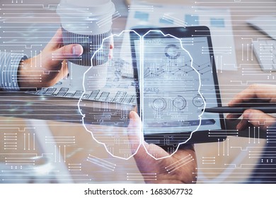 Double exposure of man's hand holding and using a digital device and brain hologram drawing. Data concept.