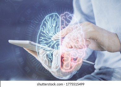 Double exposure of man's hand holding and using a digital device and brain hologram drawing. Data concept.