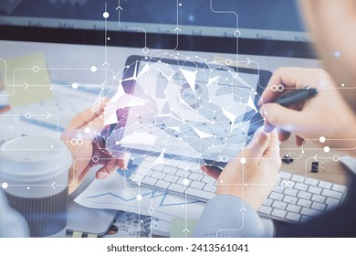 Double exposure of man's hand holding and using a digital device and brain hologram drawing. Data concept.