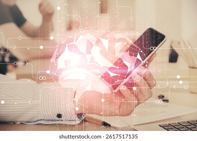 Double exposure of man's hand holding and using a digital device and brain hologram drawing. Data concept.