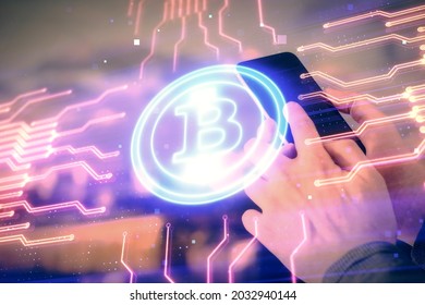 Double exposure of man's hands holding and using a phone and crypto currency blockchain theme drawing. - Shutterstock ID 2032940144