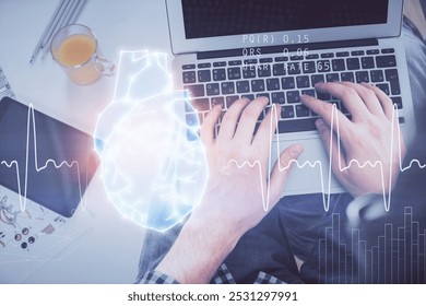 Double exposure of man's hands typing over computer keyboard and human heart hologram drawing. Top view. Medical education concept. - Powered by Shutterstock