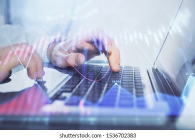 Double exposure of market chart with man working on computer on background. Concept of financial analysis. - Shutterstock ID 1536702383