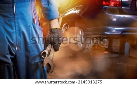 Double exposure mechanic fix and repairing car engine automobile vehicle parts screwing using tools wrench equipment working in garage support and service in overall work uniform.