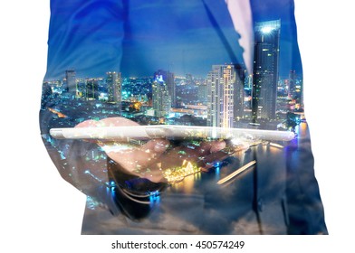 Double Exposure Of Night City And Business Man Using Digital Tablet Device As Business Development Concept.