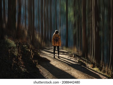 Double Exposure Photography With ICM Technique, Intentional Camera Movement. Woman With Yellow Coat In The Forest. Concept Of Vertigo, Fear, Overcoming, Tranquillity. Motion Blur.