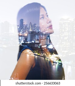 Double Exposure Portrait Of An Asian Working Woman Thinking About Big City At Night.