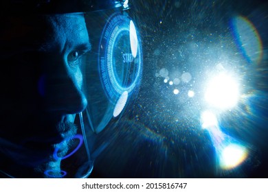 Double exposure portrait of futuristic astronaut in spacesuit with holographic interface to display data. Astronomy conception. Distant galaxies and deep space. Spacecraft In Outer Space.