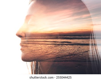 Double exposure portrait of a woman combined with photograph of nature