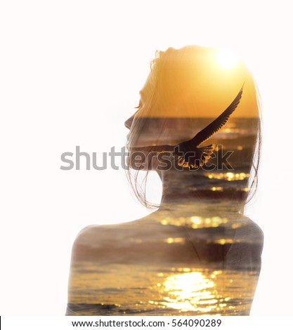 Double exposure portrait of a young woman combined with photograph of flying bird in sunset reflecting in ocean. Conceptual image showing unity of human with nature. Ecology, freedom, environment