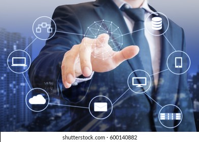 Double exposure of professional businessman touch on screen connected devices with  digital technology internet and wireless network and city of business background in business and technology concept