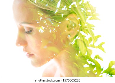 Double exposure profile portrait of a young, happy natural blonde woman with long hair dissolving into the bright leaves of a tropical plant  - Powered by Shutterstock