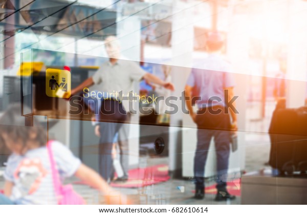 Double exposure of 
security check airport sign ,Airport security check at gates with
metal detector and
scanner