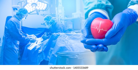 Double exposure Several surgeons surrounding patient on operation table during their work and Doctor or surgeon holding a Heart.Doctor hands holding red heart with cardiogram, health care concept.