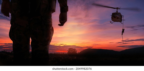 Double exposure silhouette back side view soldier helicopter under army training at sunset mountain twilight sky background. - Powered by Shutterstock