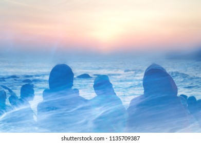 double exposure of the silhouette of people watching the sunset over the Indian Ocean with clouds over layered on top.  Kanyakumari, India. - Shutterstock ID 1135709387